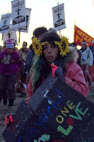 A young Native American girl marches with other Water Protectors toward the DAPL construction site.